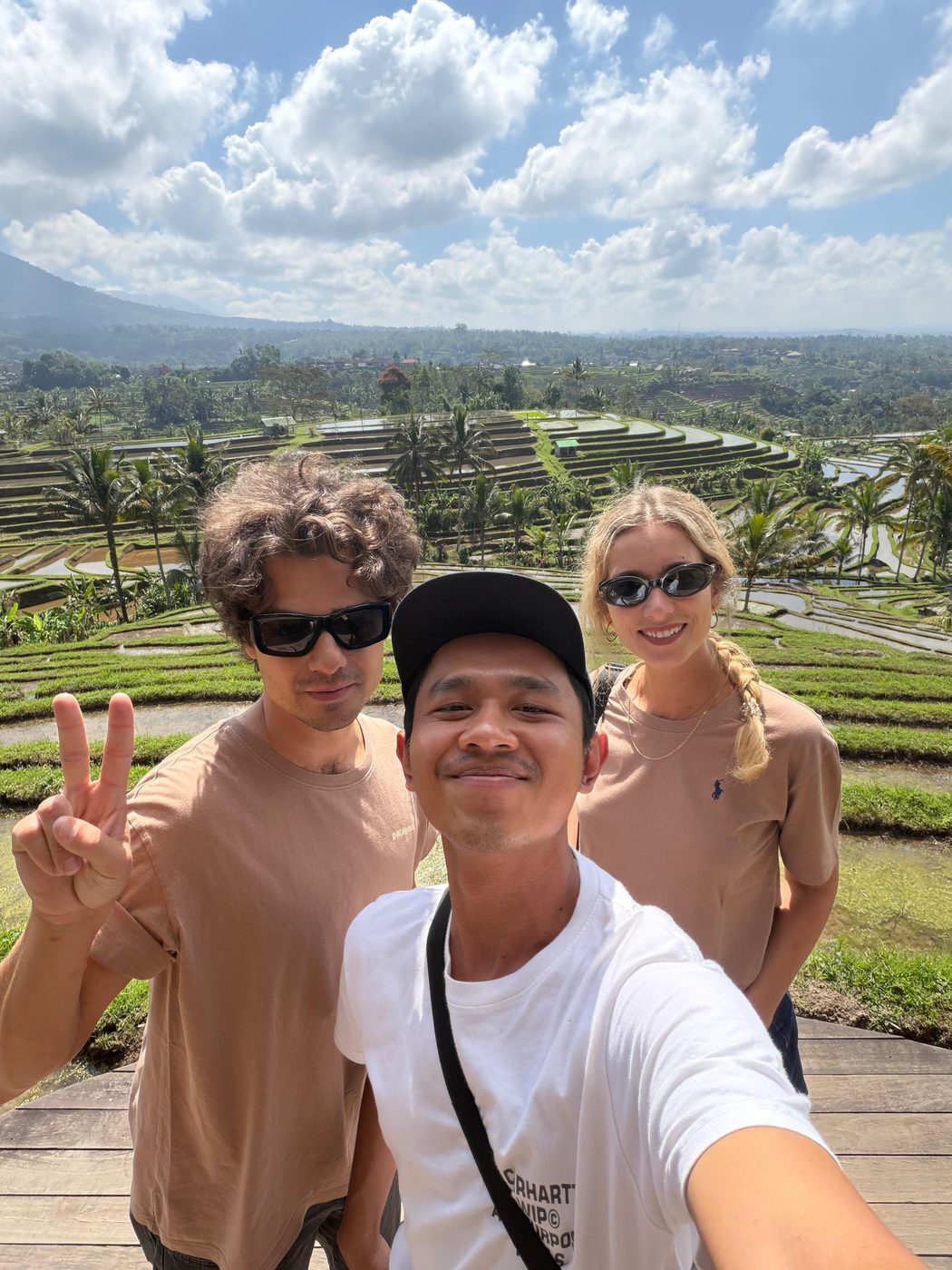 Batuh, Bali private driver, with two guests above the Tegallalang rice terraces area